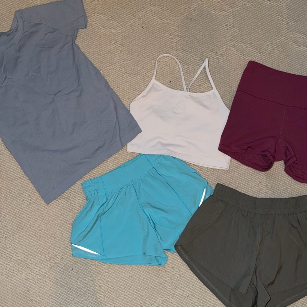 Athletic Apparel Bundle with white tank, blue short sleeve, and colorful shorts